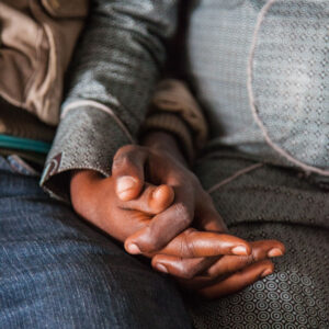 Two people hold hands. Photo: Perttu Saralampi.